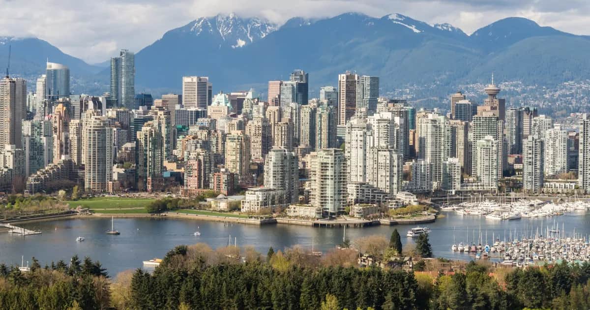 Downtown Vancouver's towers and marina beneath the snow-capped North Shore mountains
