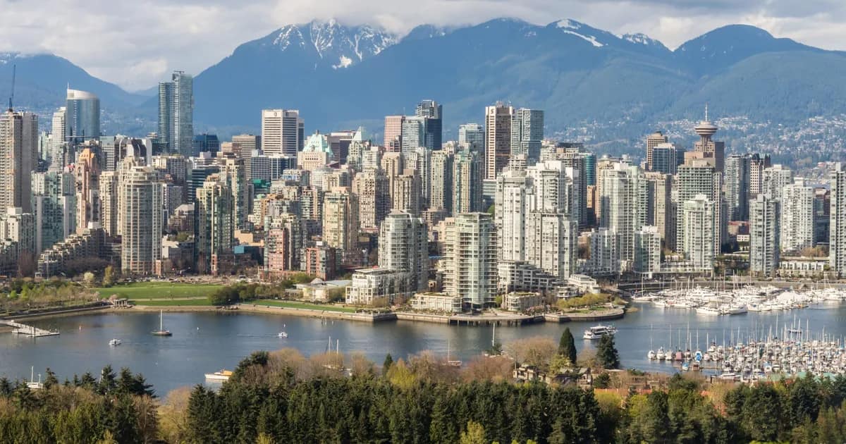 Downtown Vancouver's towers and marina beneath the snow-capped North Shore mountains