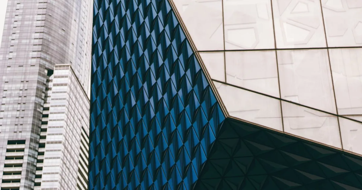 Faceted glass facade of a downtown Toronto building beside a neighbouring office tower