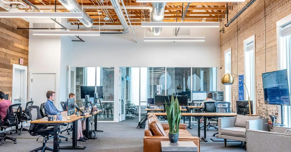 Staffed open-plan office with employees at work — a real operating presence for a Canadian MSB